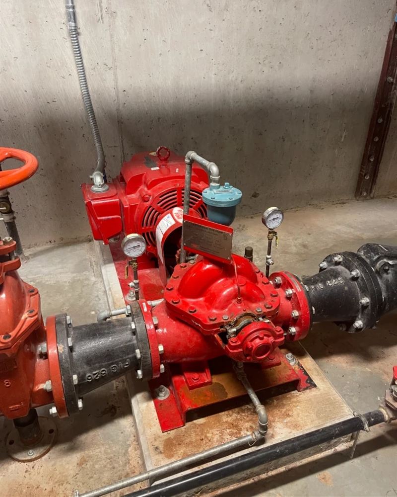 Red split-case fire pump in a concrete pump room