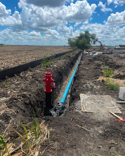 New fire hydrant set on an underground water line in an open trench
