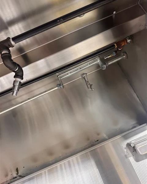 Kitchen hood suppression piping and nozzles inside the hood plenum